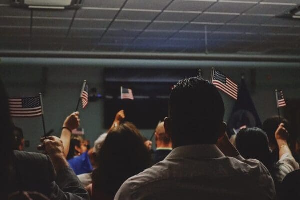 immigrants waving american flags