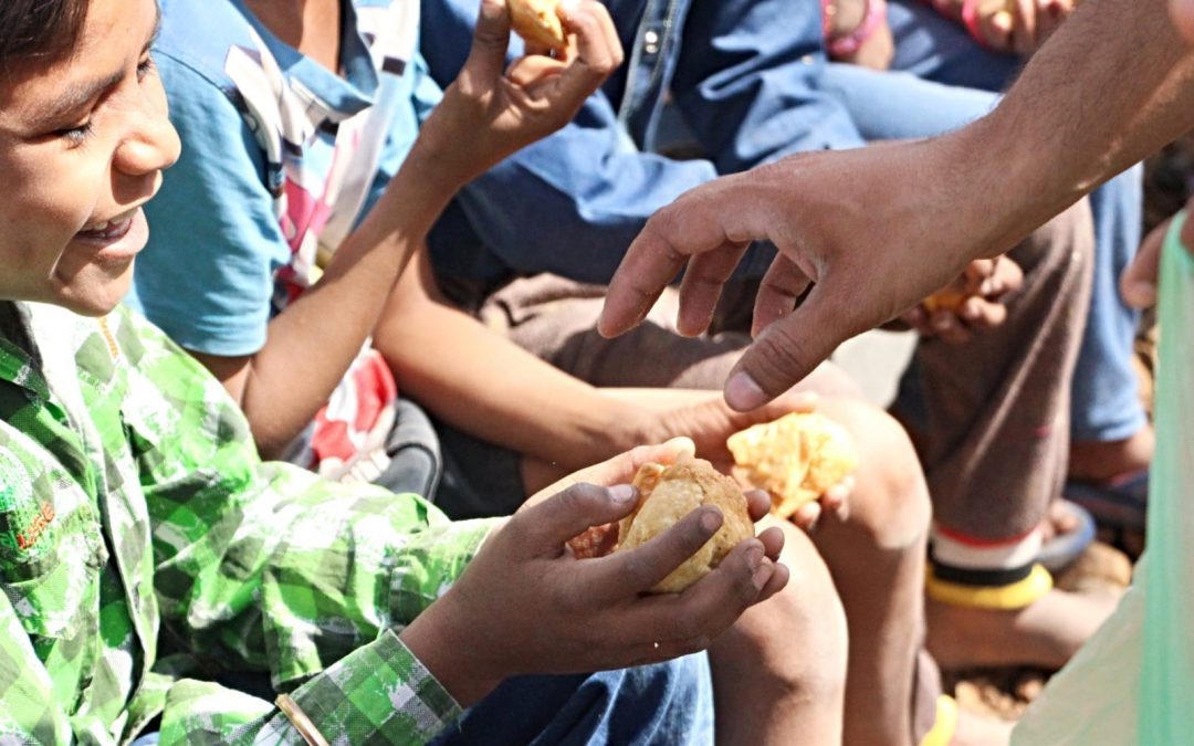 Young children being given bread