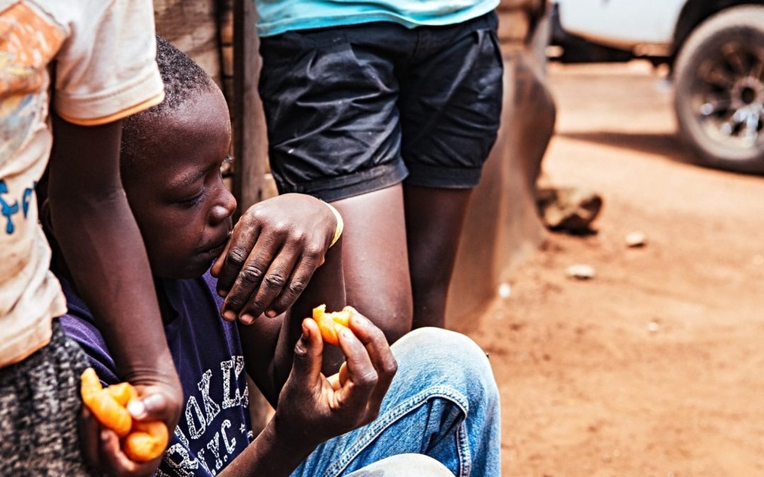 Boy sitting down and eating food