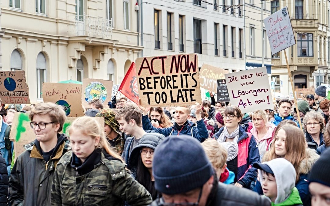 Protesters holding signs about climate change