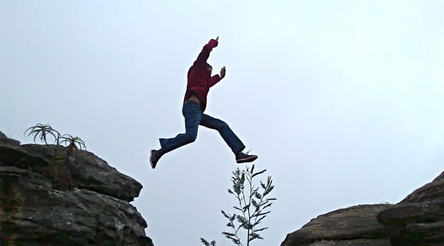 Man leaping across chasm