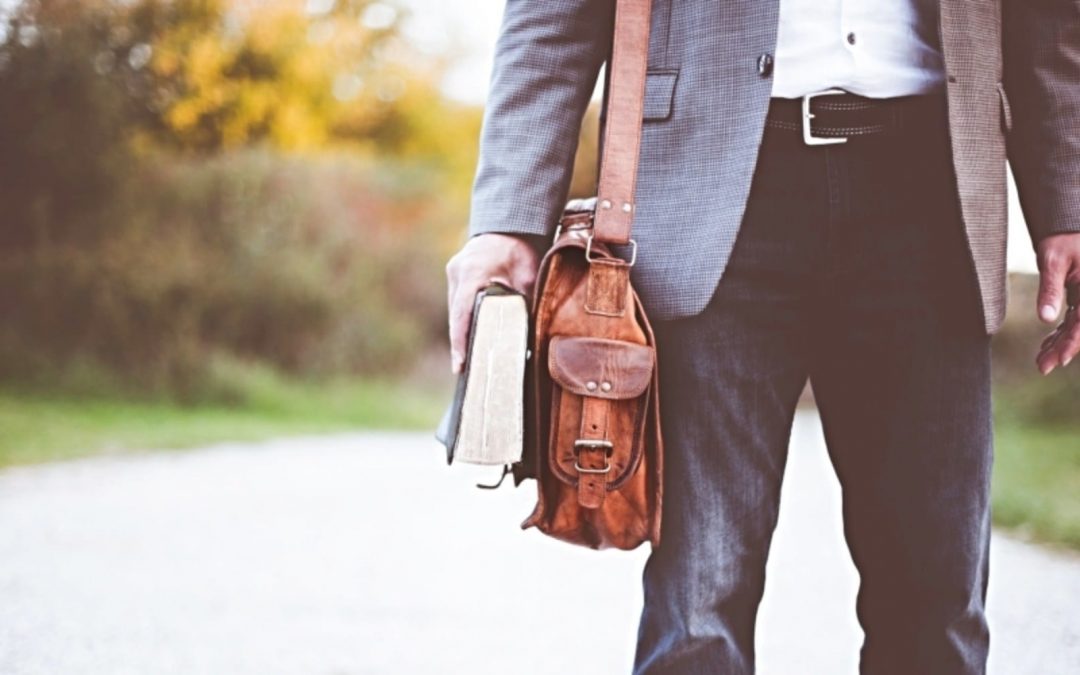 Man holding Bible outside