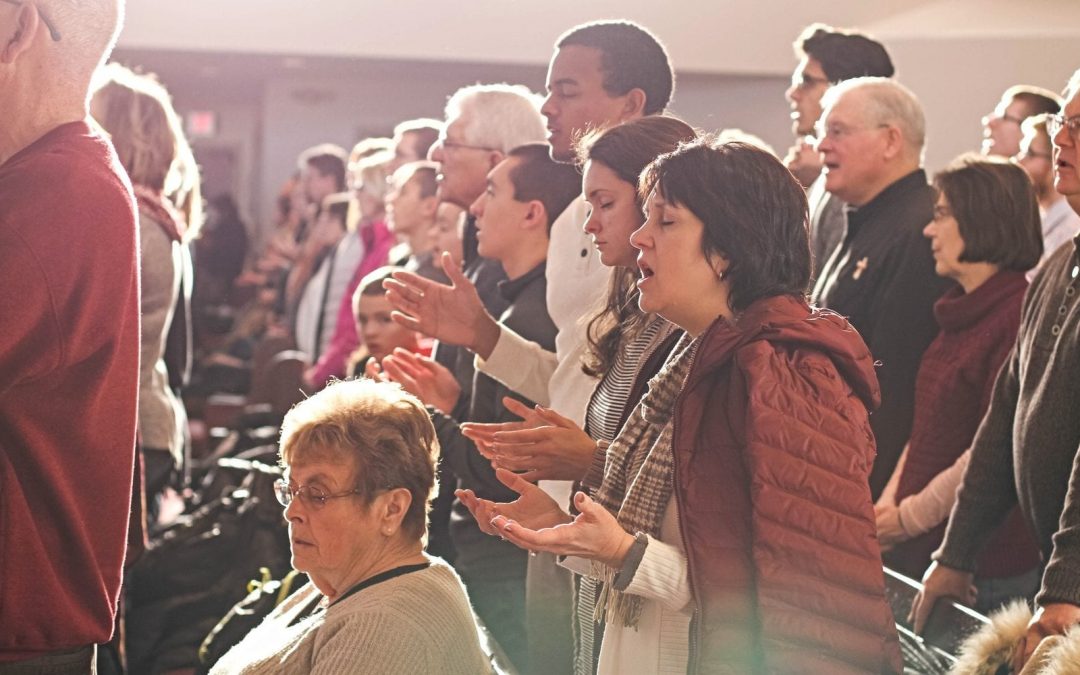 Church members standing in pews and singing