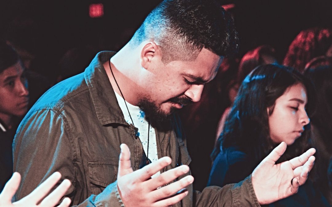 Man praying in worship service