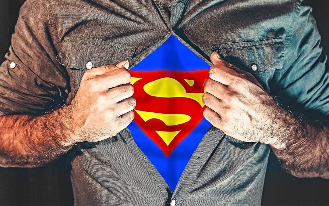 Man ripping shirt to reveal Superman costume