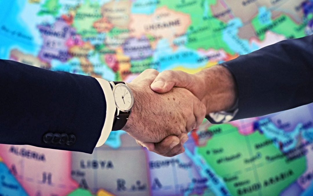 Handshake in front of map of Europe