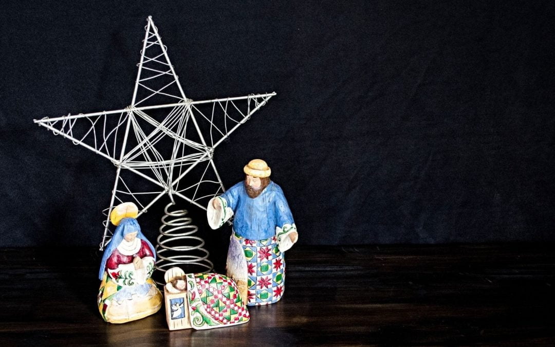 Figures of Mary, Joseph and Jesus with star in background